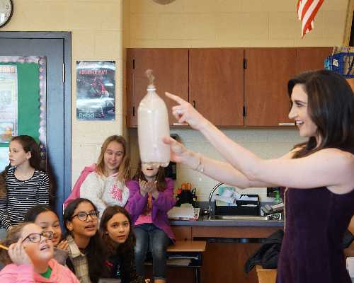 woman showing a science demonstration.