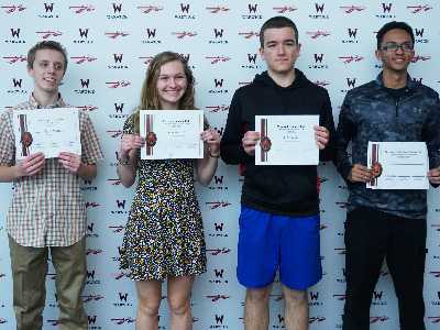 engineering students pose for photo at science fair awards.